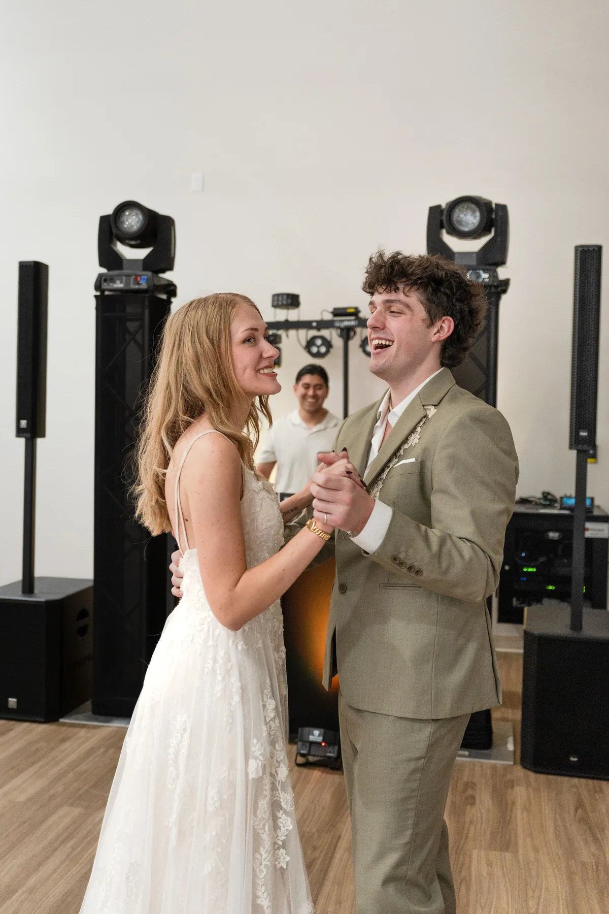 Wedding couple dancing with DJ Foca performing in the background
